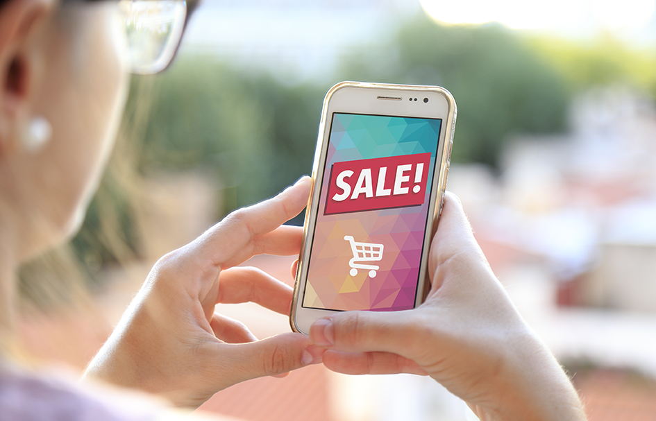 A woman in Hong Kong showcases an award-winning digital marketing campaign through a smartphone with a sale sign on it.