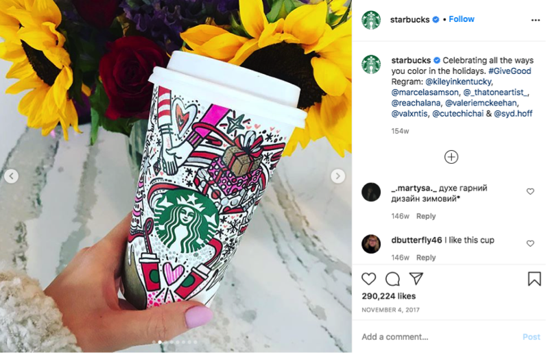 A person in Hong Kong is holding up an award-winning Starbucks cup with a flower on it.